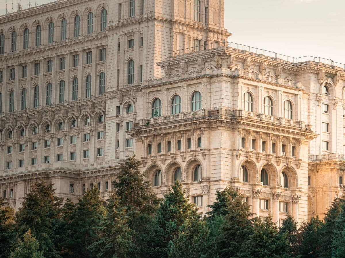 The Palace of the Parliament in Bucharest, its facade warm in the late sun